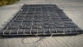 Blast mat produced from used tires, and sewn together with twelve wires